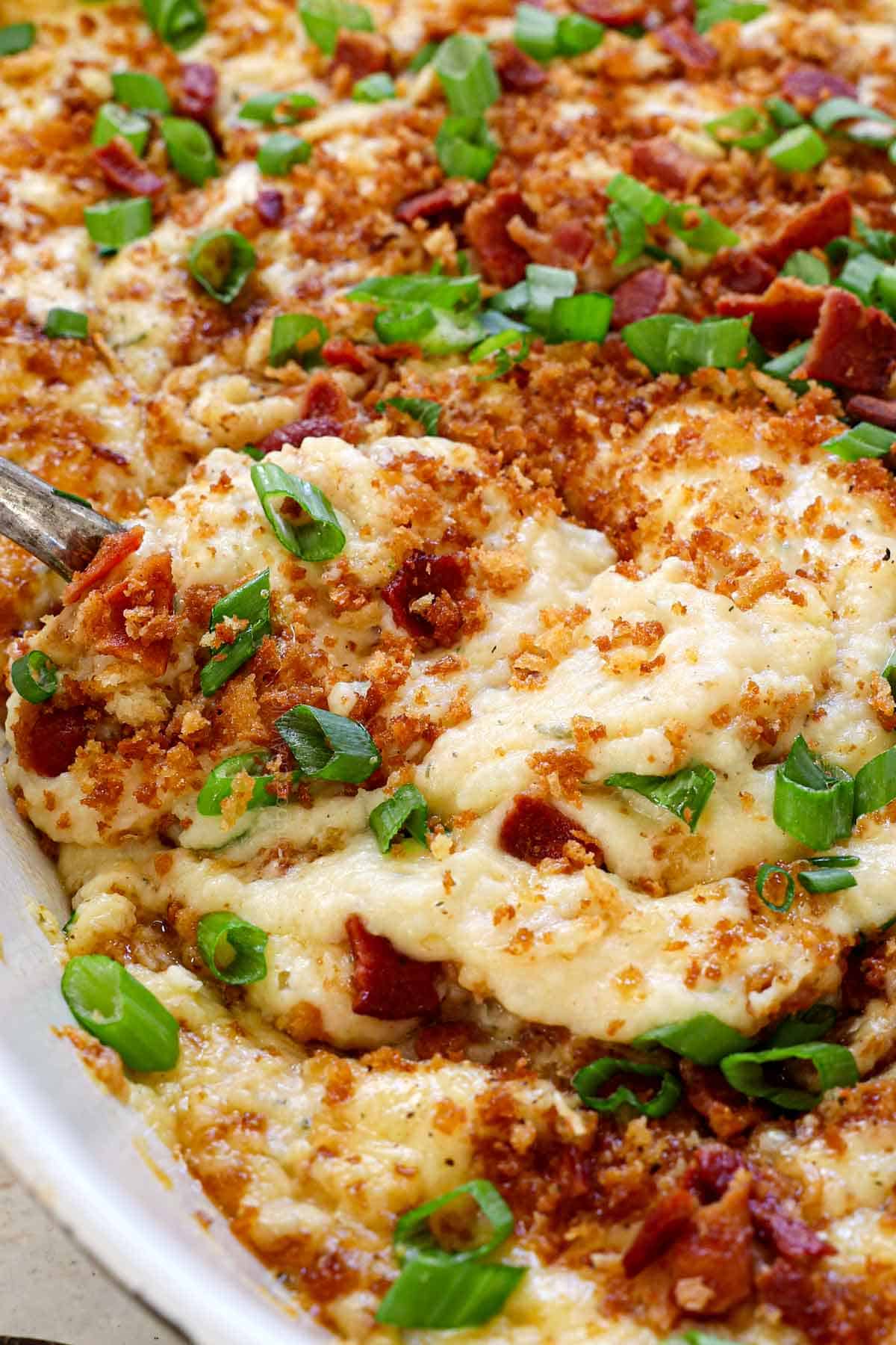 scooping up mashed potato casserole recipe showing how creamy it is
