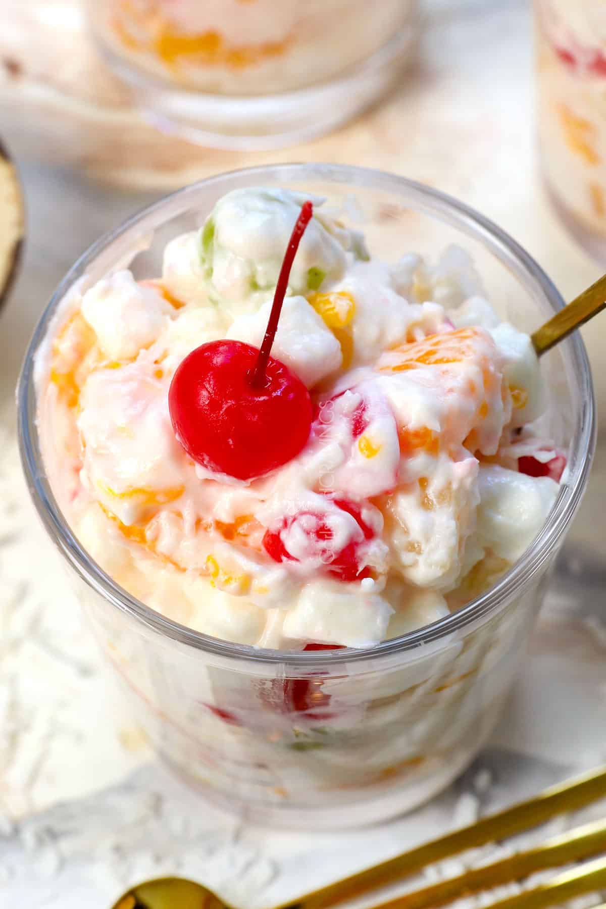 up close of ambrosia fruit salad in a glass dish