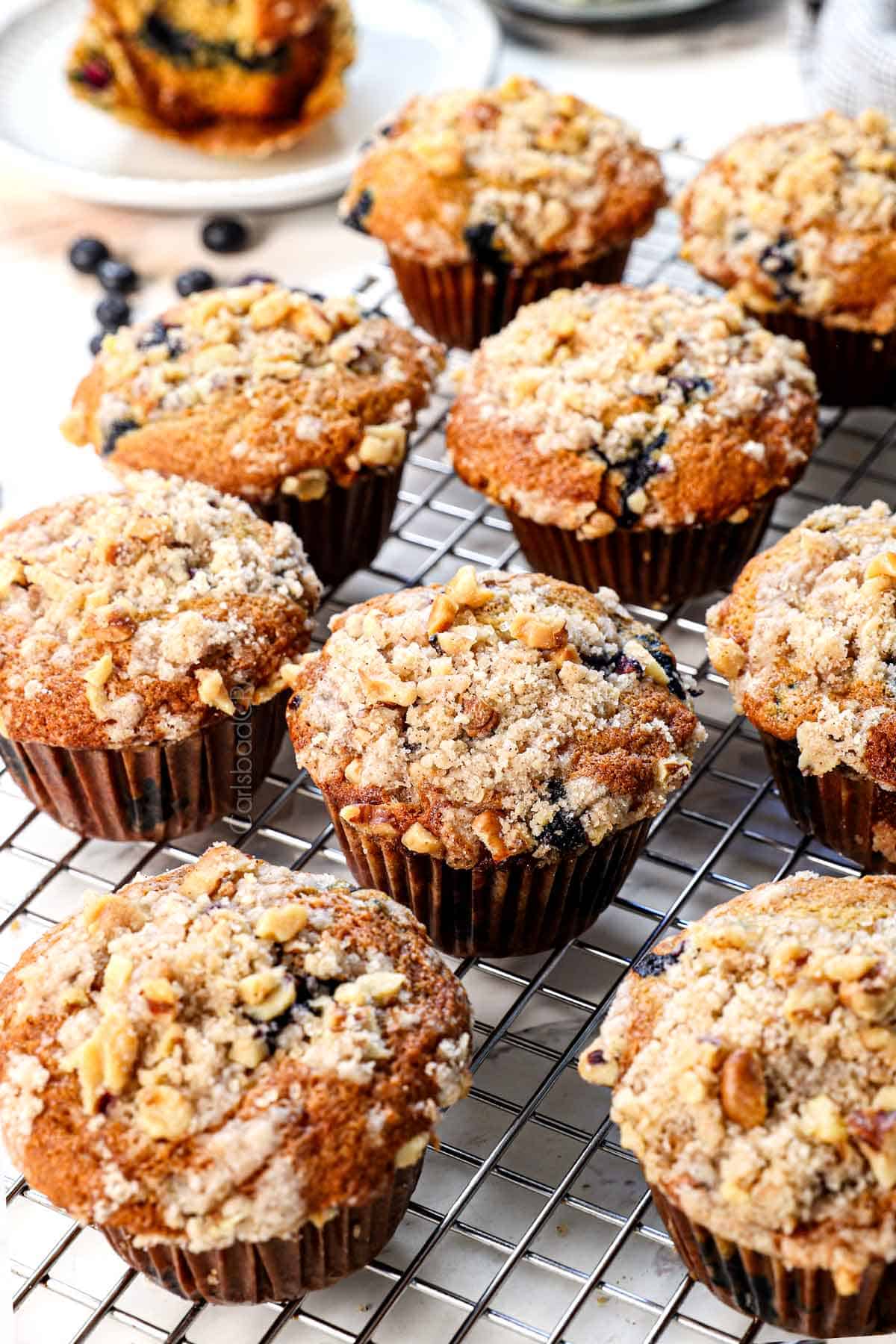 showing how to make blueberry muffins by letting them cool on a wire rack