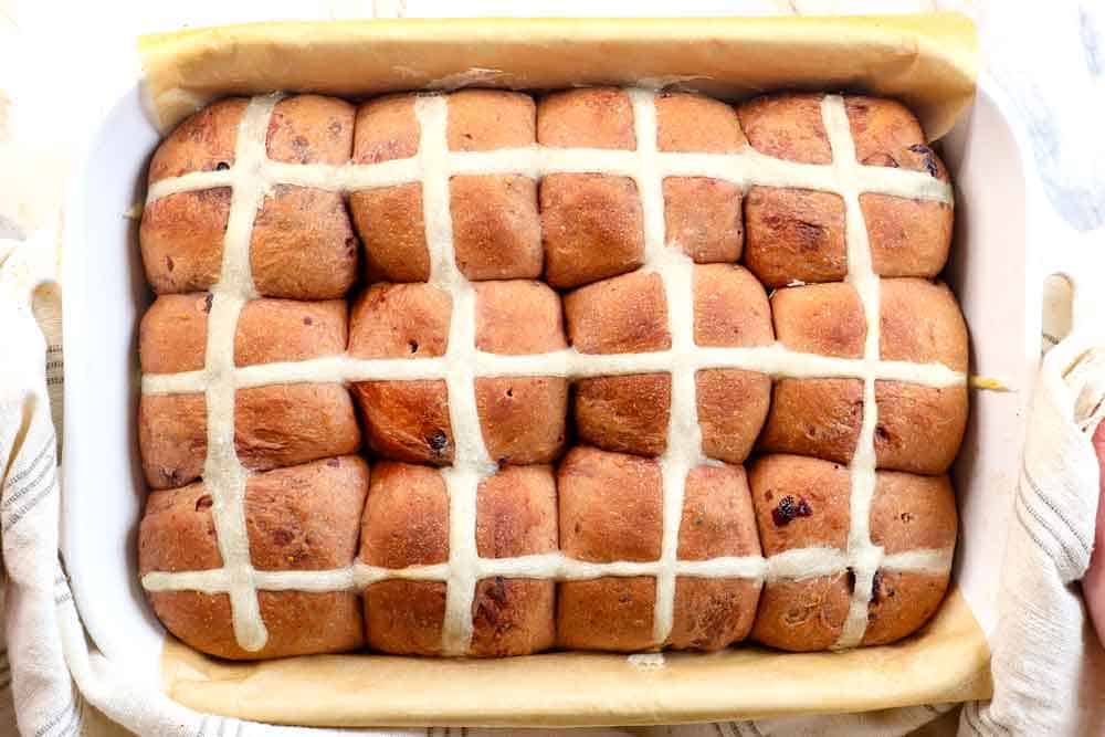 showing how to make hot cross buns by baking until deeply golden