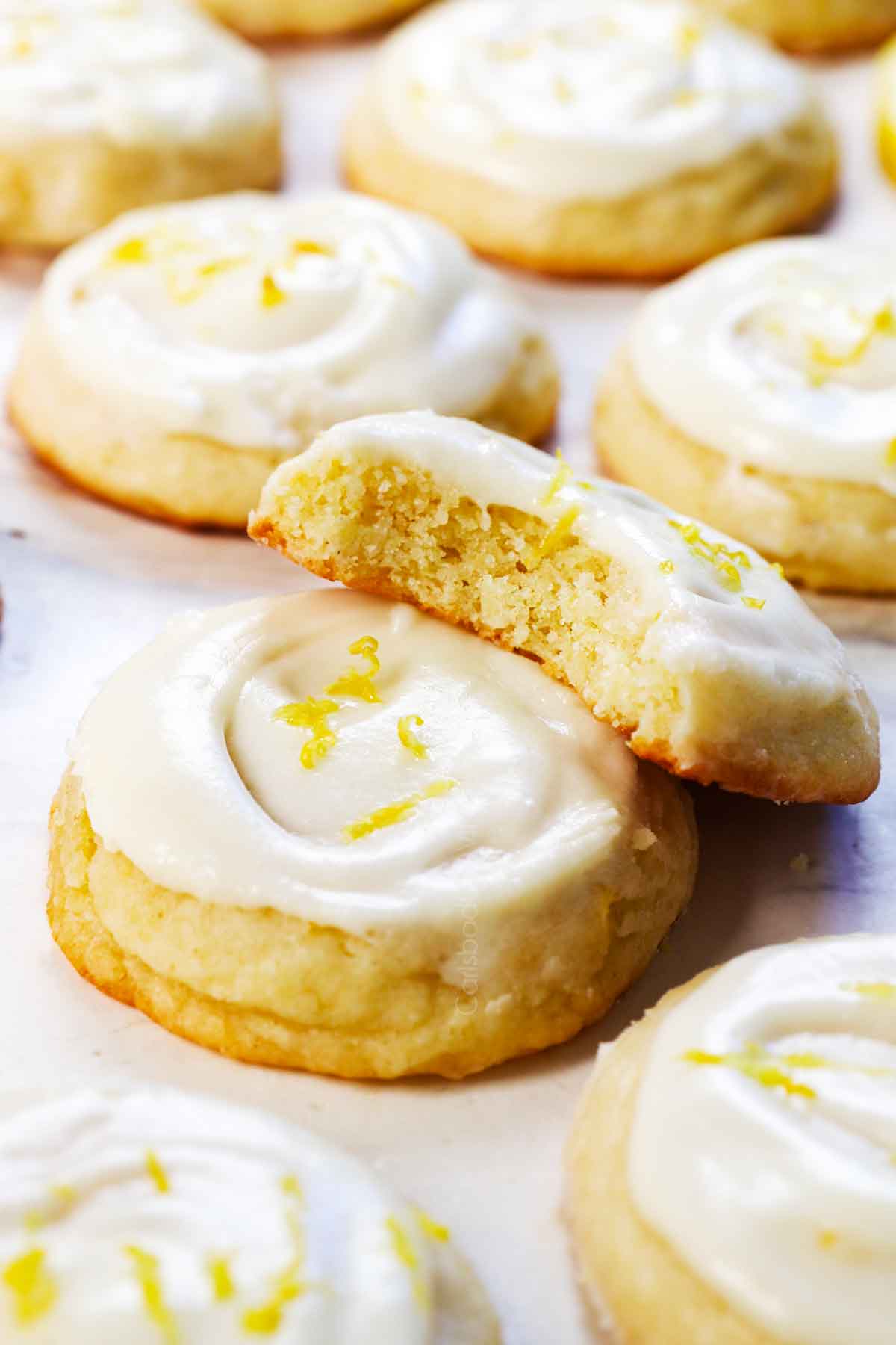 up close of a bite taken out of lemon sugar cookies showing how soft and chewy they are