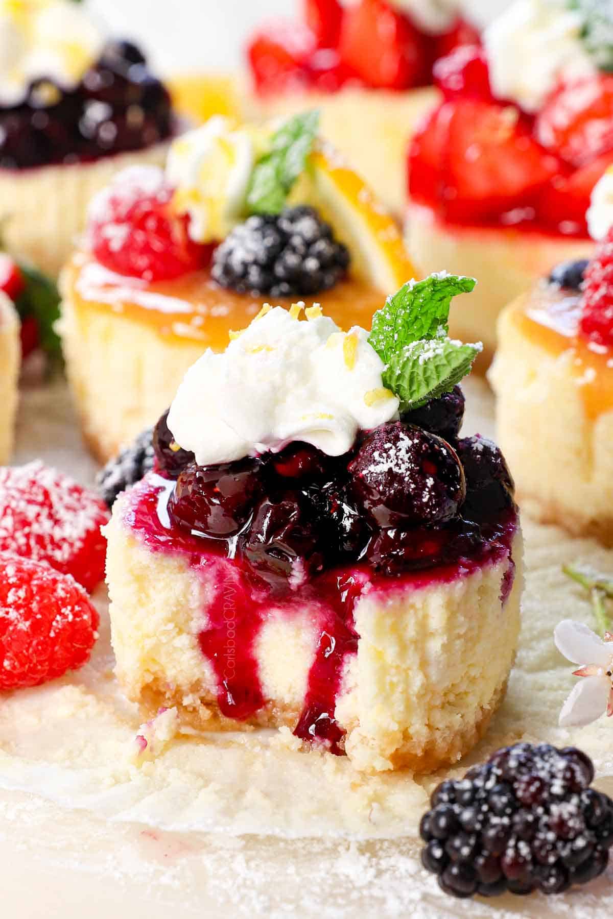 up close of mini cheesecake with a bite taken out showing how creamy it is