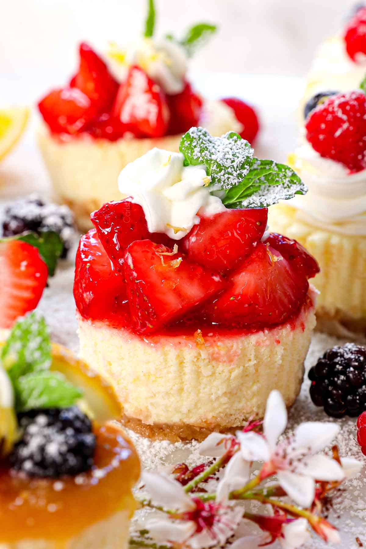 up close of mini cheesecakes recipe showing a small cheesecake topped with glazed strawberries