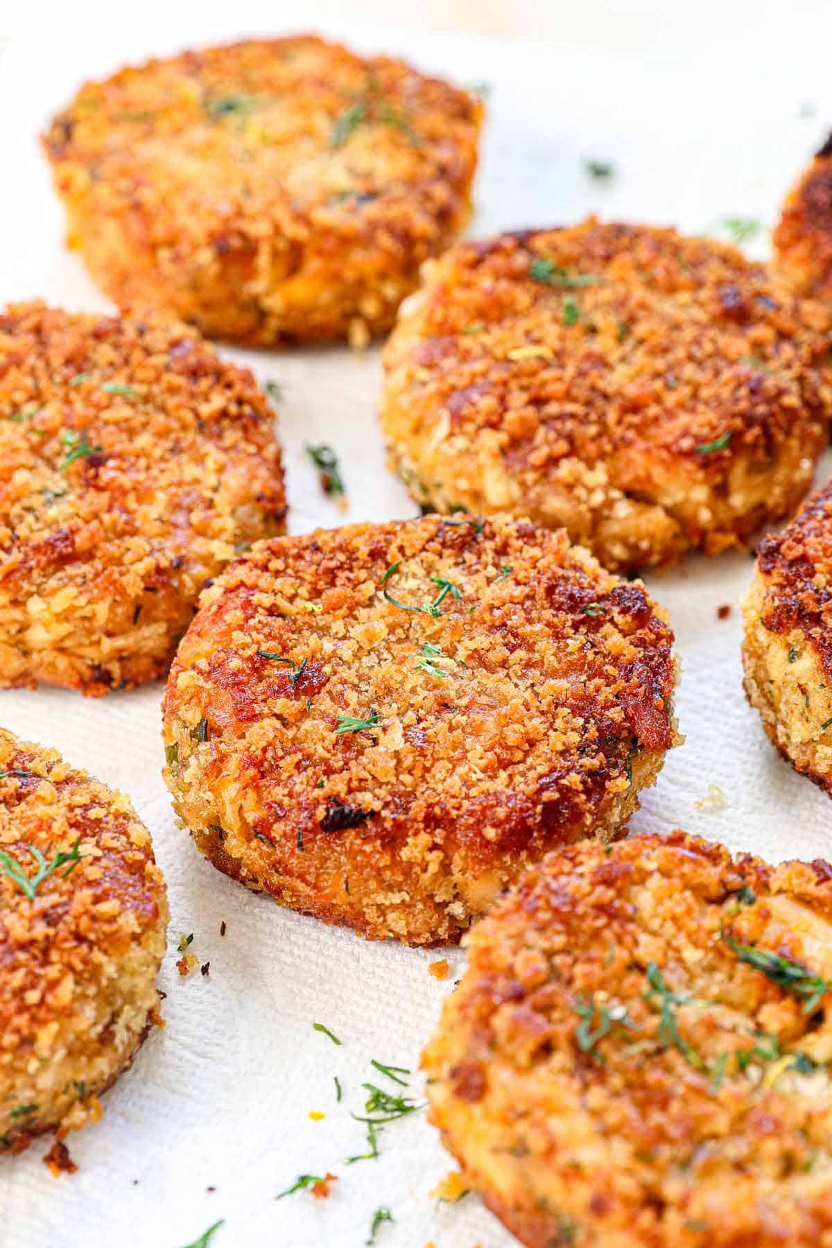 recipe for salmon croquettes being cooled on a paper towel lined wire rack