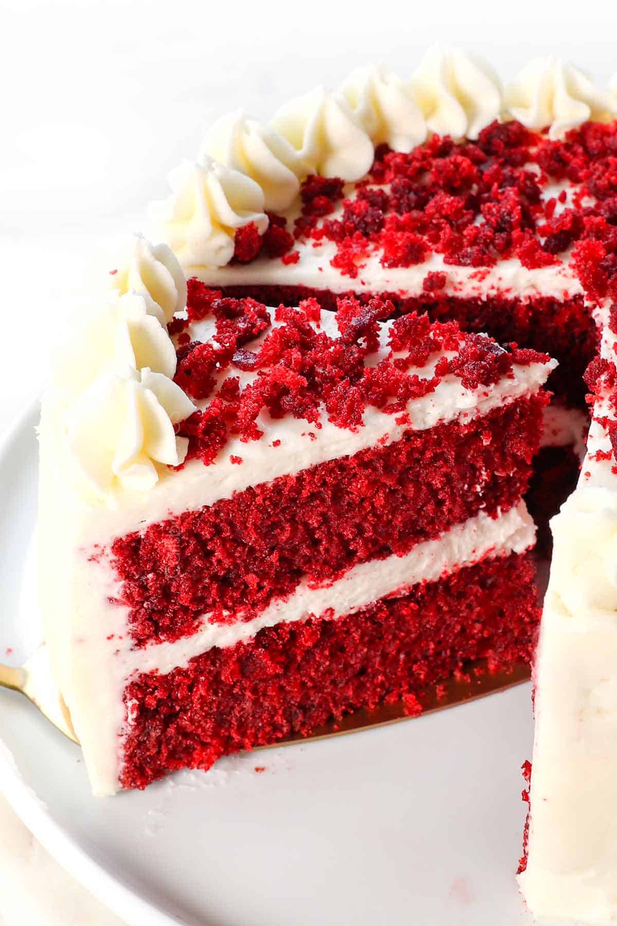 up close of homemade cream cheese frosting on red velvet cake showing how thick and stable it is