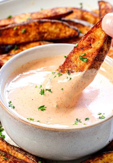 up close of dipping French fries in fry sauce showing how thick and creamy it is