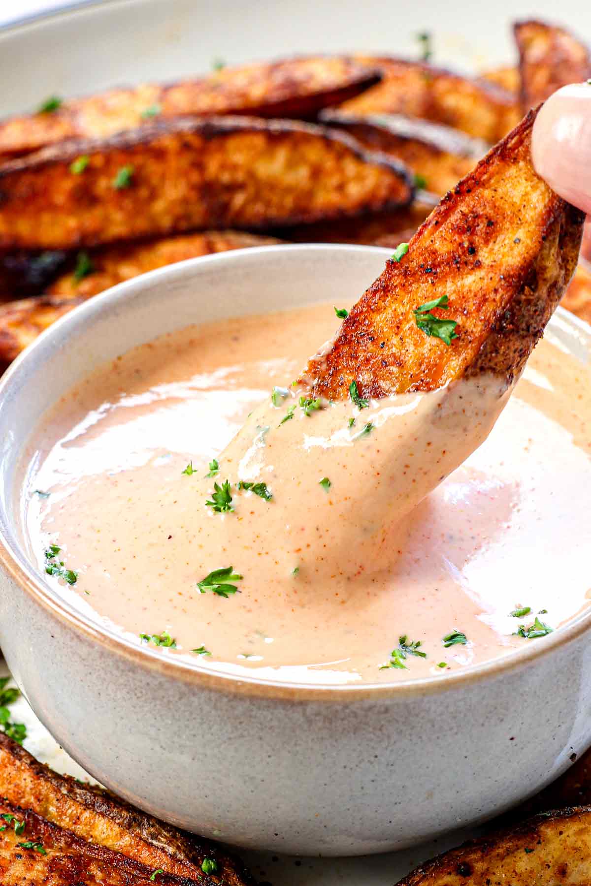 up close of dipping French fry in fry sauce showing how creamy it is